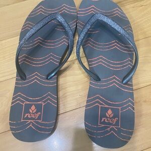 Reef Black Flip Flops with Orange Wave Accents